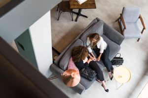 two people sitting on sofa